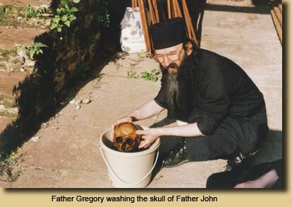 Father Gregory washing the skull of Father John