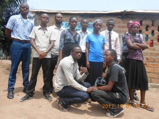 Teachers of the school standing together outside a classroom