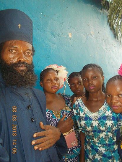 Father Theophile with girls of the parish