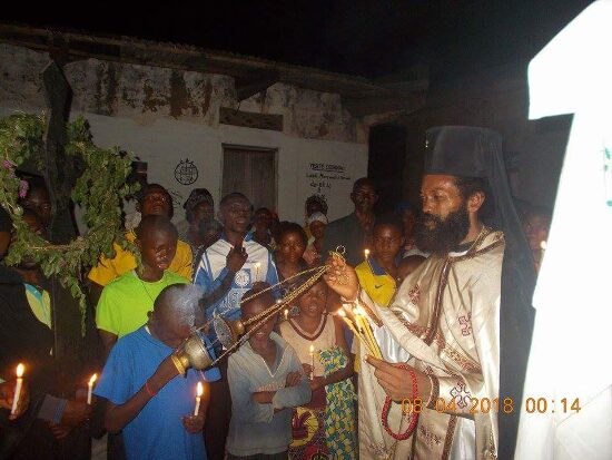 Father Theophile with the faithful holding candles in the Paschal procession
